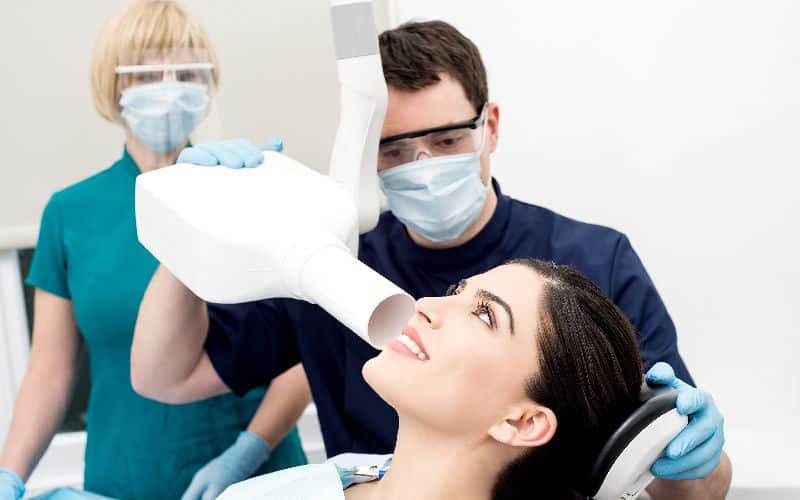 male dentist takes jaw xray female